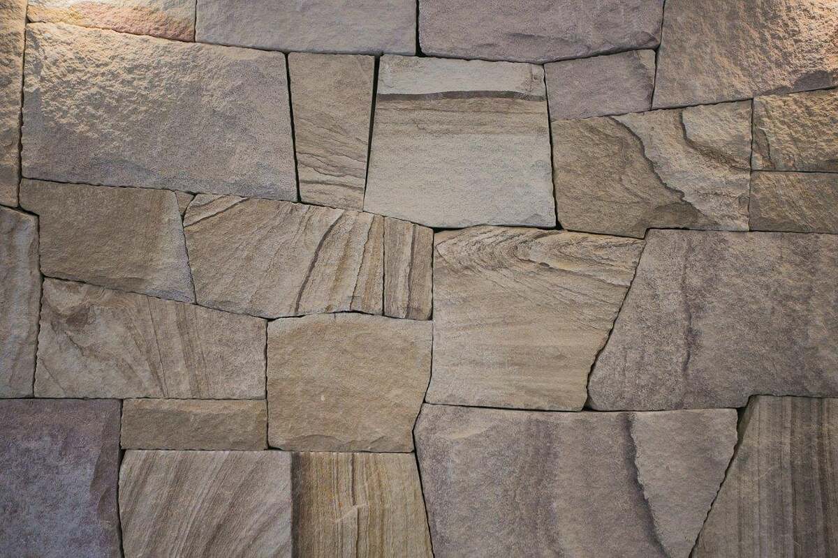 Close detail of hand-dressed Sydney sandstone laid in a tight random ashlar pattern